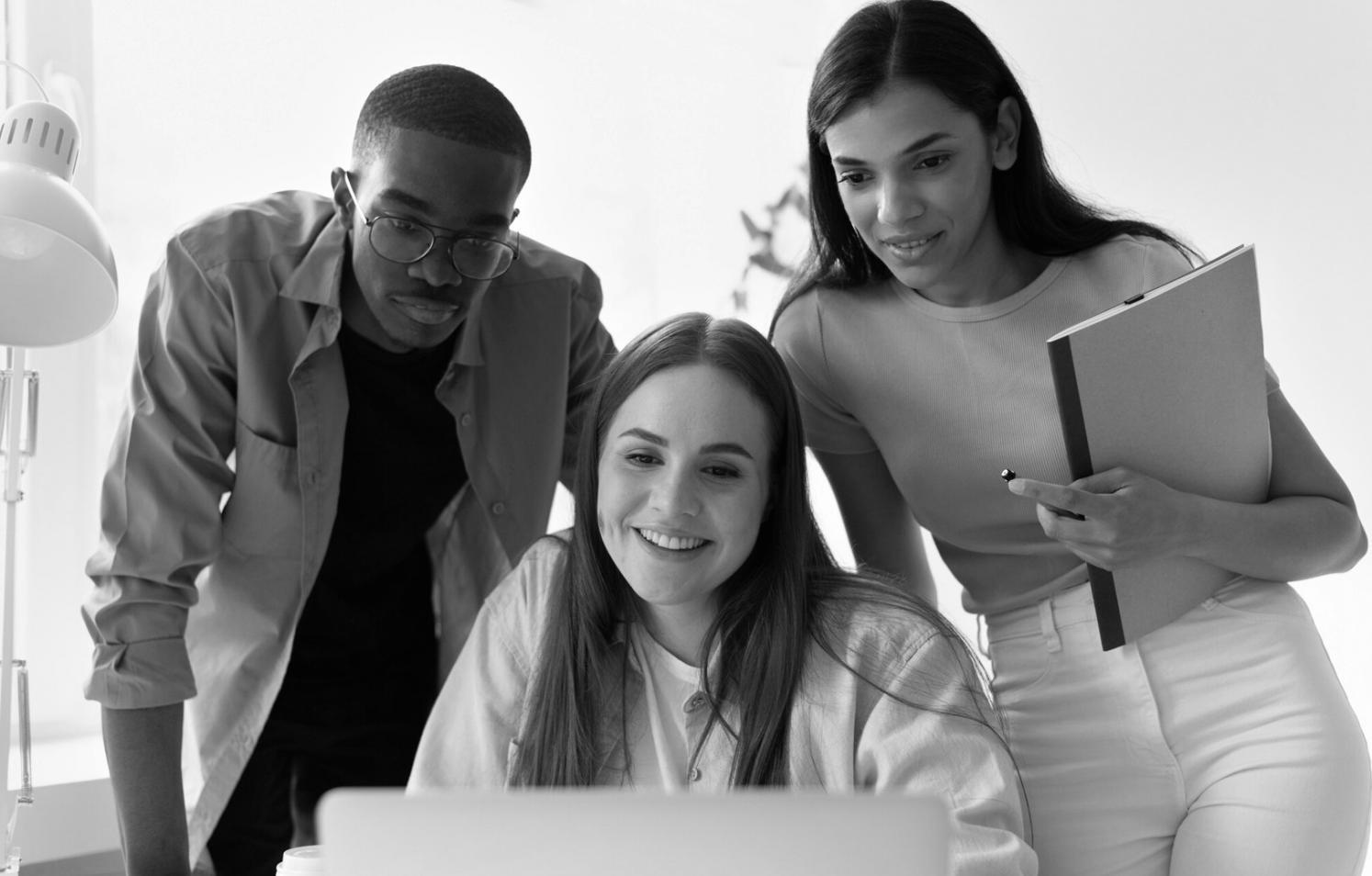 Team collaboration session with budget planning materials and laptops on modern workspace